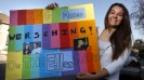 Allison Draper holding "Annie Wersching on Ellen" poster